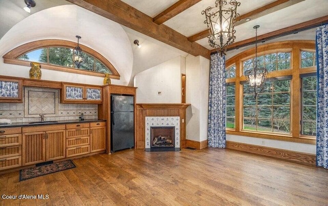 7566 E Gem Shores Rd, Hayden, ID 83835 - interior space featuring an inviting chandelier, dark wood finished floors, a sink, and a healthy amount of sunlight