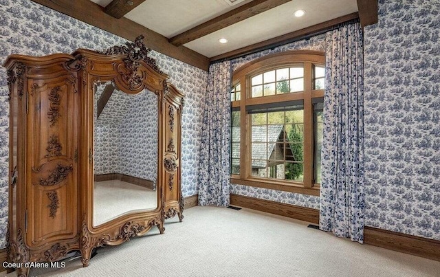 7566 E Gem Shores Rd, Hayden, ID 83835 - interior space featuring visible vents, carpet floors, baseboards, beamed ceiling, and wallpapered walls