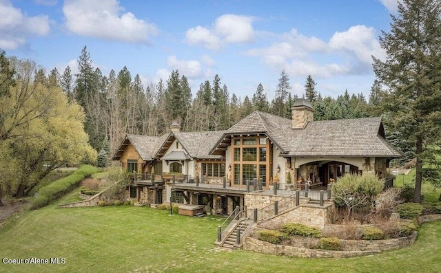 7566 E Gem Shores Rd, Hayden, ID 83835 - rear view of house with a chimney, a lawn, a deck, stairway, and stone siding