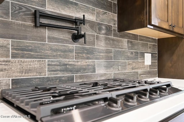 room details featuring stainless steel gas stovetop and tasteful backsplash