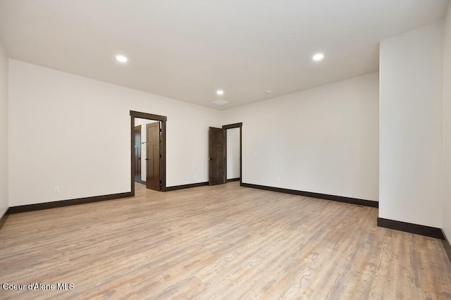 unfurnished room with recessed lighting, baseboards, and light wood finished floors
