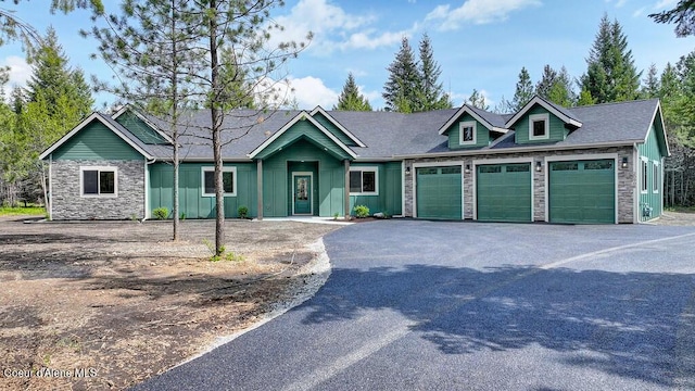 20908 Ranch View Dr, Rathdrum, ID 83858 - view of front of house featuring a garage, stone siding, asphalt driveway, and board and batten siding