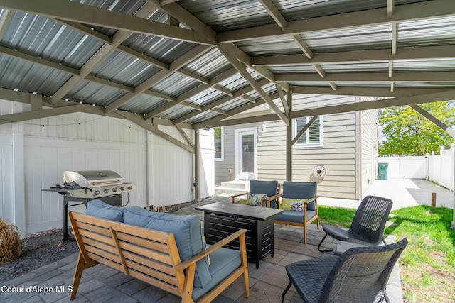 view of patio with an outdoor living space, fence, and area for grilling