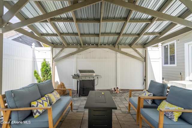 view of patio with grilling area, outdoor lounge area, and fence private yard