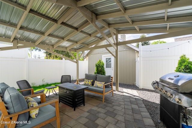 view of patio / terrace with grilling area, an outdoor living space, and a fenced backyard