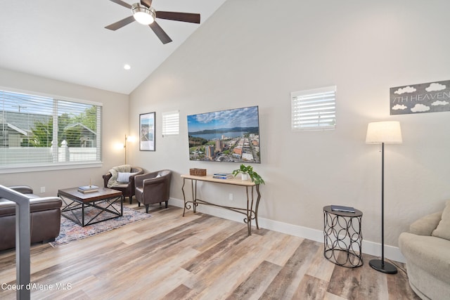 living area featuring ceiling fan, wood finished floors, high vaulted ceiling, baseboards, and recessed lighting