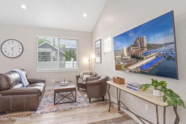 living area featuring baseboards, vaulted ceiling, recessed lighting, and wood finished floors