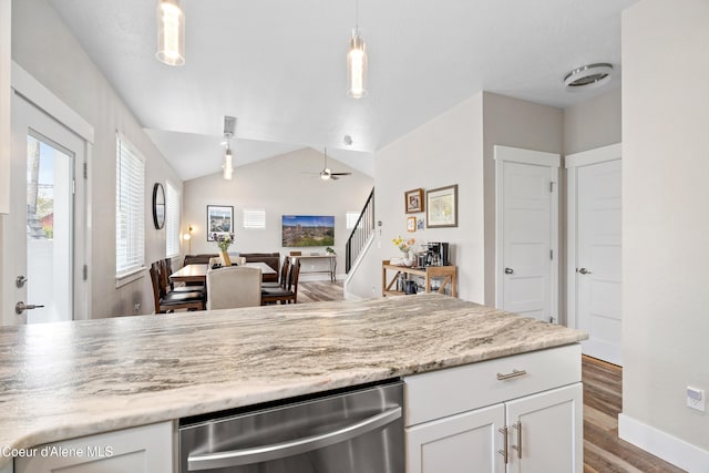 kitchen with white cabinets, a ceiling fan, open floor plan, wood finished floors, and vaulted ceiling