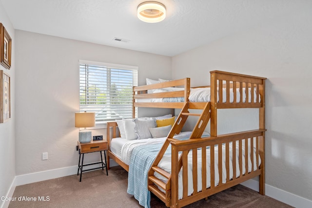 carpeted bedroom with baseboards and visible vents
