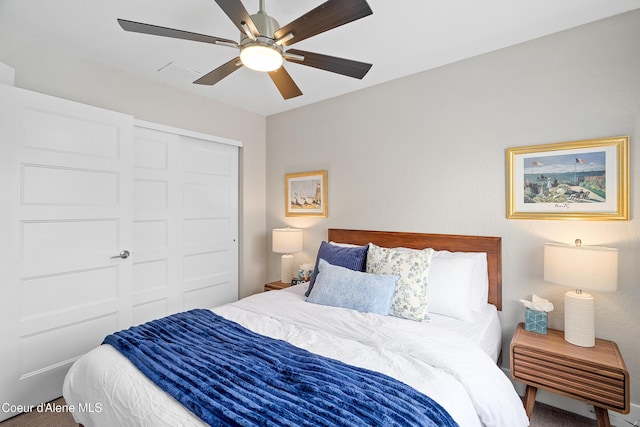 carpeted bedroom featuring a ceiling fan, visible vents, and a closet