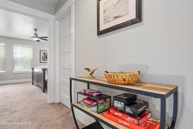 hall featuring carpet floors and baseboards