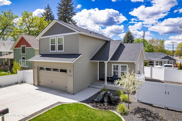 view of front of house featuring fence, concrete driveway, a shingled roof, and an attached garage