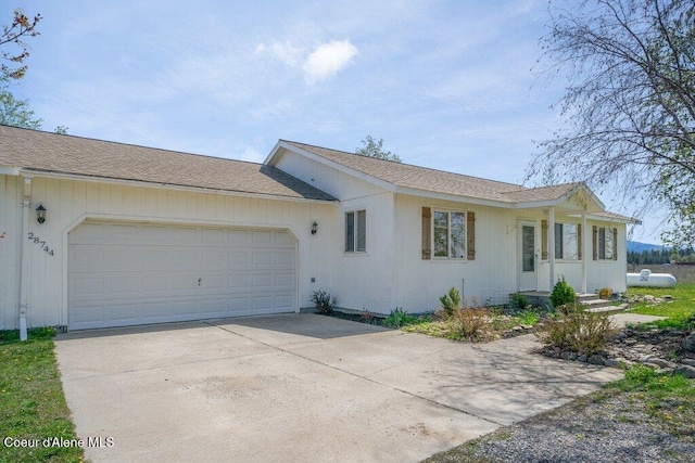 single story home featuring a garage and concrete driveway