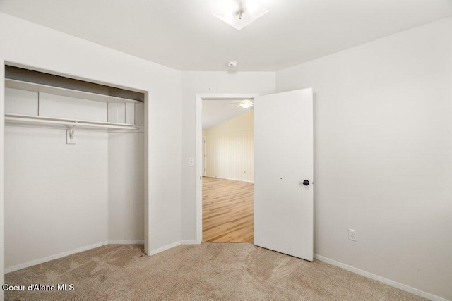 unfurnished bedroom with a closet, baseboards, and carpet flooring