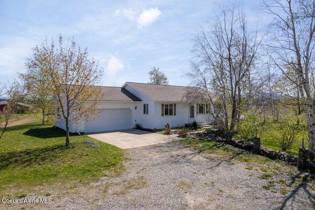 single story home with a garage, a front yard, and concrete driveway