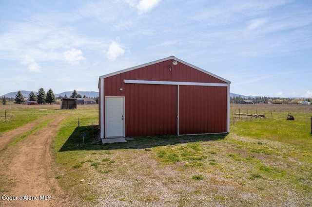 view of pole building with a mountain view and a rural view