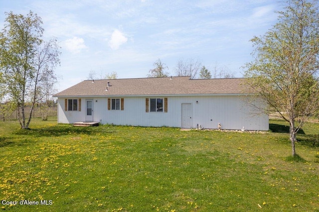 back of property with a yard