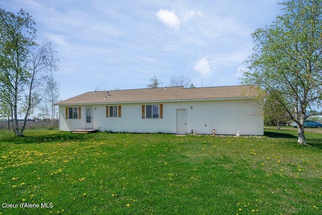 back of house featuring a yard