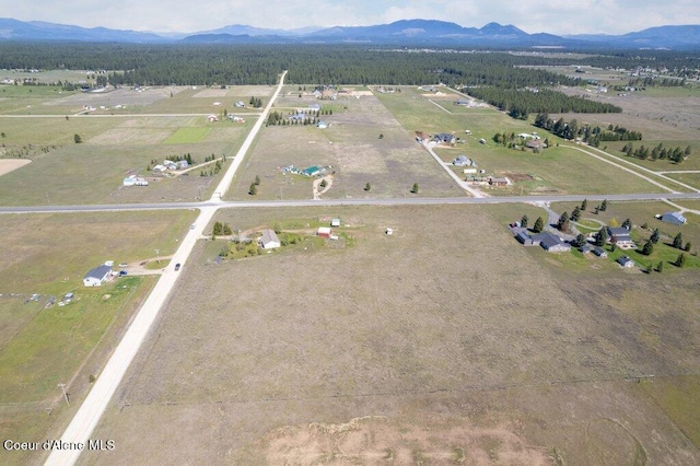 birds eye view of property featuring a mountain view and a rural view