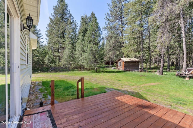 130 Stone Haven Dr, Blanchard, ID 83804 - wooden deck with a lawn, an outbuilding, and a storage unit