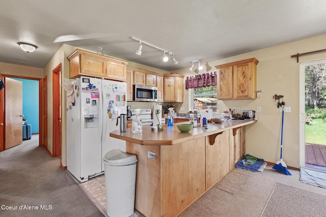 130 Stone Haven Dr, Blanchard, ID 83804 - kitchen featuring white refrigerator with ice dispenser, stainless steel microwave, a peninsula, electric stove, and light carpet