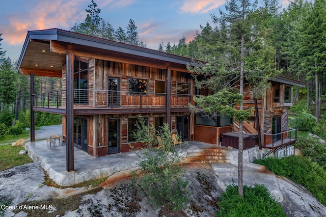 172 Elk Hills Rd, Sandpoint, ID 83864 - back of property featuring a patio area, a hot tub, and a balcony