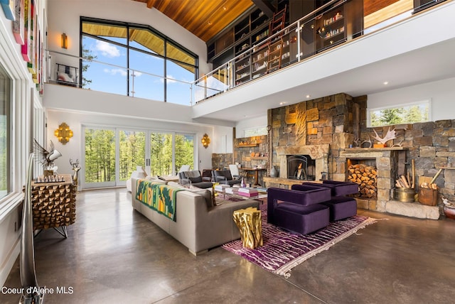 172 Elk Hills Rd, Sandpoint, ID 83864 - living room with finished concrete flooring, a fireplace, and a towering ceiling