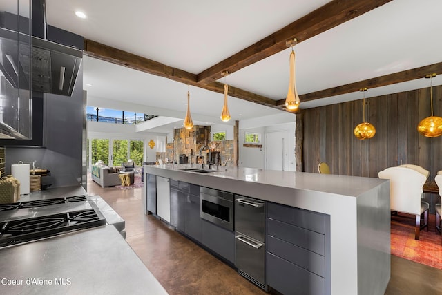 172 Elk Hills Rd, Sandpoint, ID 83864 - kitchen featuring a sink, open floor plan, wooden walls, modern cabinets, and beamed ceiling