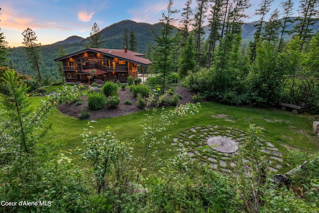 172 Elk Hills Rd, Sandpoint, ID 83864 - view of green lawn featuring a deck with mountain view