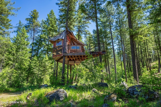172 Elk Hills Rd, Sandpoint, ID 83864 - view of play area with a deck and a view of trees