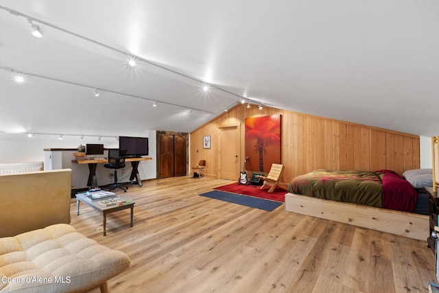 172 Elk Hills Rd, Sandpoint, ID 83864 - bedroom featuring track lighting, wood finished floors, wood walls, and vaulted ceiling