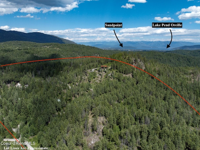 172 Elk Hills Rd, Sandpoint, ID 83864 - aerial view of property's location with a heavily wooded area, a mountainous background, and property boundaries highlighted
