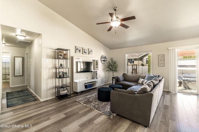 living room with plenty of natural light, ceiling fan, wood finished floors, and visible vents