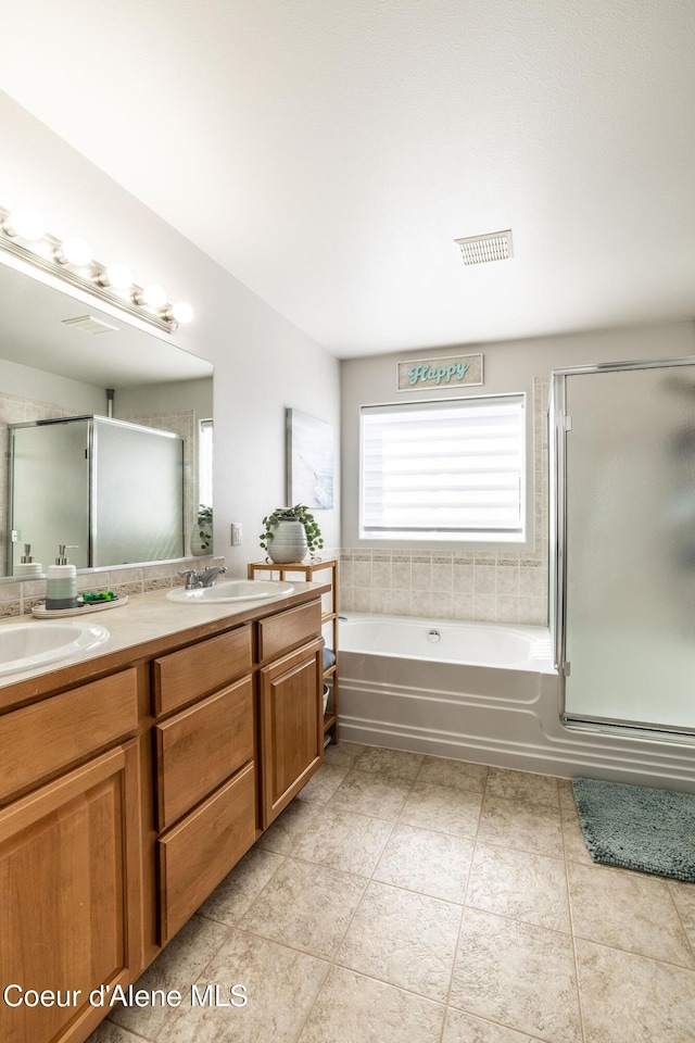 full bath with a shower with shower door, double vanity, a sink, and a bath