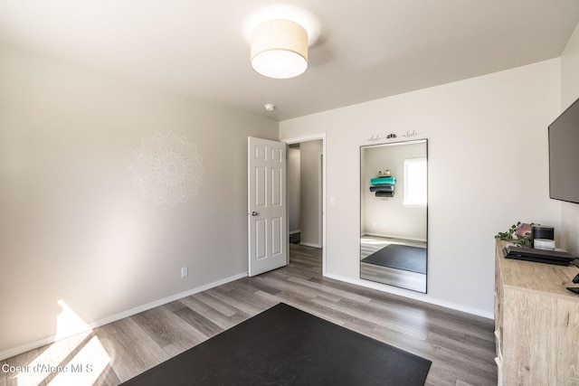 unfurnished bedroom featuring baseboards and wood finished floors