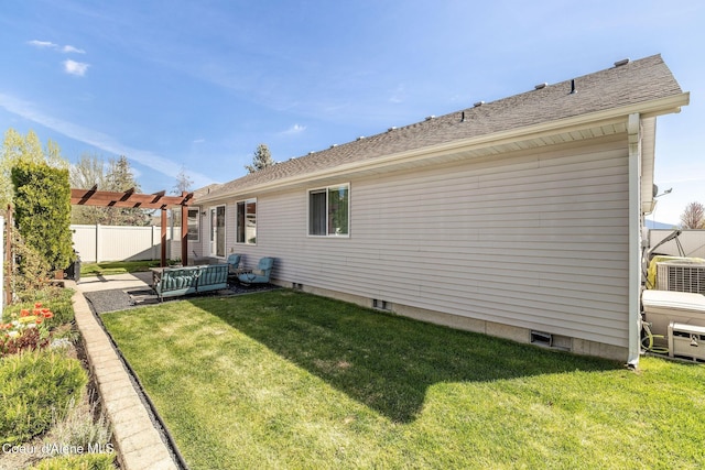 back of property with fence, roof with shingles, central AC unit, an outdoor living space, and a yard
