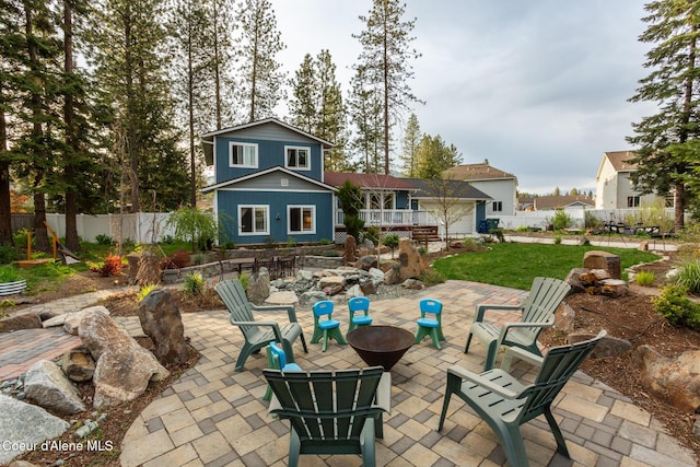 back of property featuring a patio, fence, a deck, and an outdoor fire pit