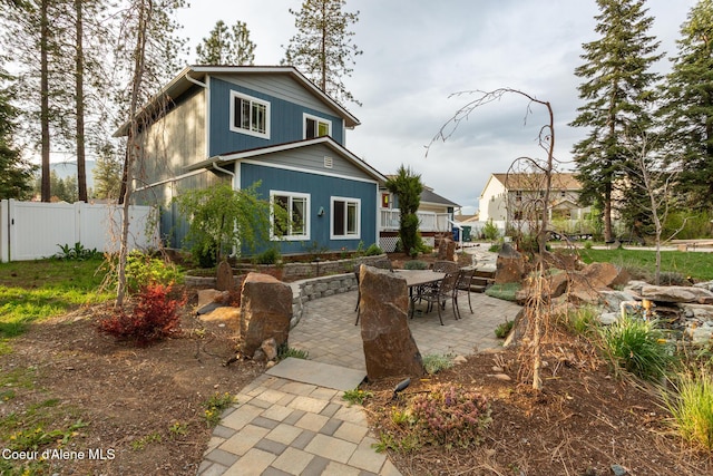 back of property with a patio and fence