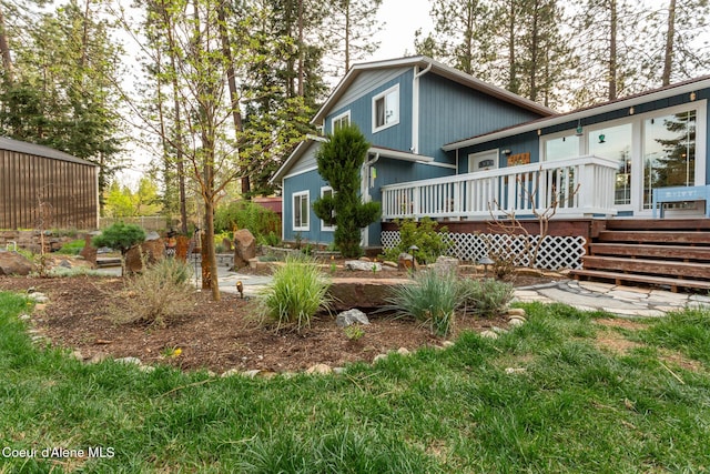rear view of house with a wooden deck