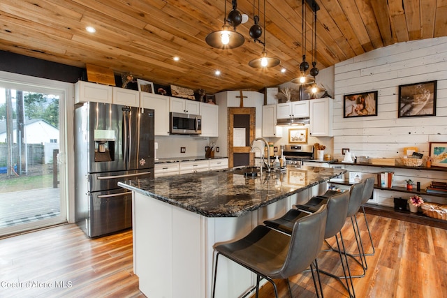 kitchen with wood ceiling, a sink, white cabinets, stainless steel appliances, and light wood-style flooring