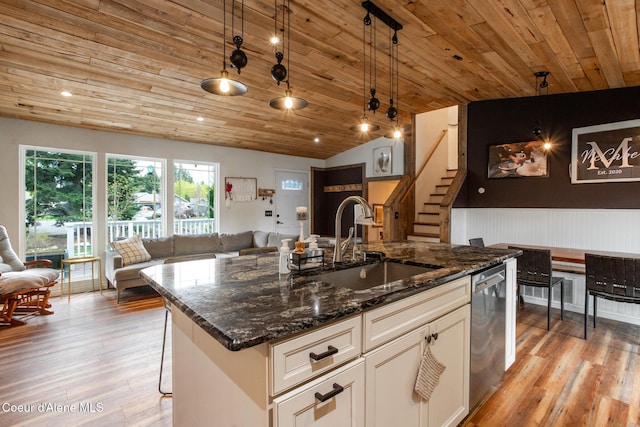 kitchen with a sink, light wood-style floors, open floor plan, wooden ceiling, and stainless steel dishwasher
