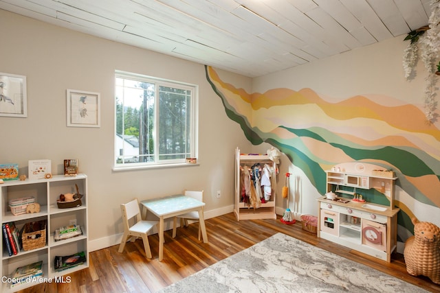 rec room featuring wooden ceiling, baseboards, and wood finished floors