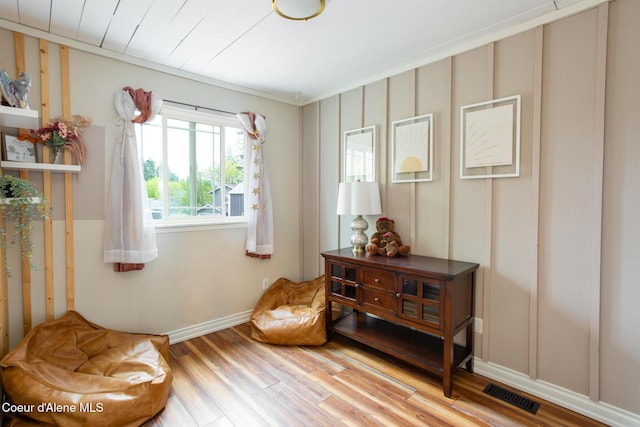 sitting room featuring wood finished floors and visible vents