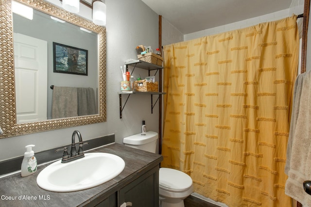 bathroom featuring toilet, a shower with curtain, and vanity