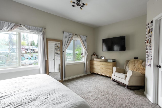 carpeted bedroom featuring baseboards