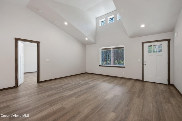 24903 N Old Highway 95, Athol, ID 83801 - unfurnished living room with light wood-type flooring, recessed lighting, and high vaulted ceiling