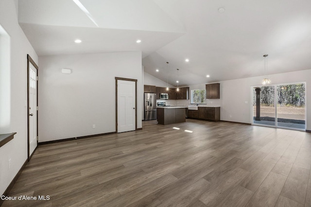 24903 N Old Highway 95, Athol, ID 83801 - unfurnished living room with recessed lighting, wood finished floors, and high vaulted ceiling