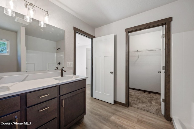24903 N Old Highway 95, Athol, ID 83801 - bathroom with wood finished floors, a shower, double vanity, and a walk in closet