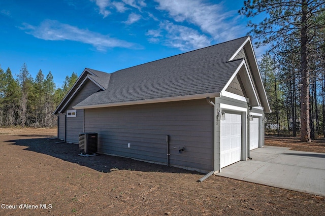 24903 N Old Highway 95, Athol, ID 83801 - view of property exterior with a garage, roof with shingles, and driveway