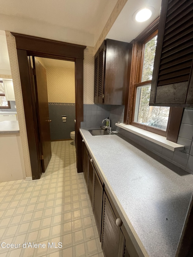 6990 Denver St, Bonners Ferry, ID 83805 - bathroom featuring toilet, tile patterned floors, decorative backsplash, and vanity